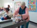 Lucille Jackson adds handwritten notes to care kits.